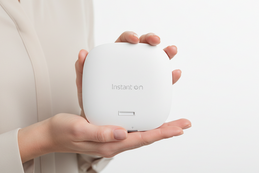 HP Aruba Instant On R4W04A white wireless access point mounted on a wall.